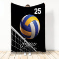 Volleyball throw blanket with blue and yellow volleyball artwork and net design on a black background