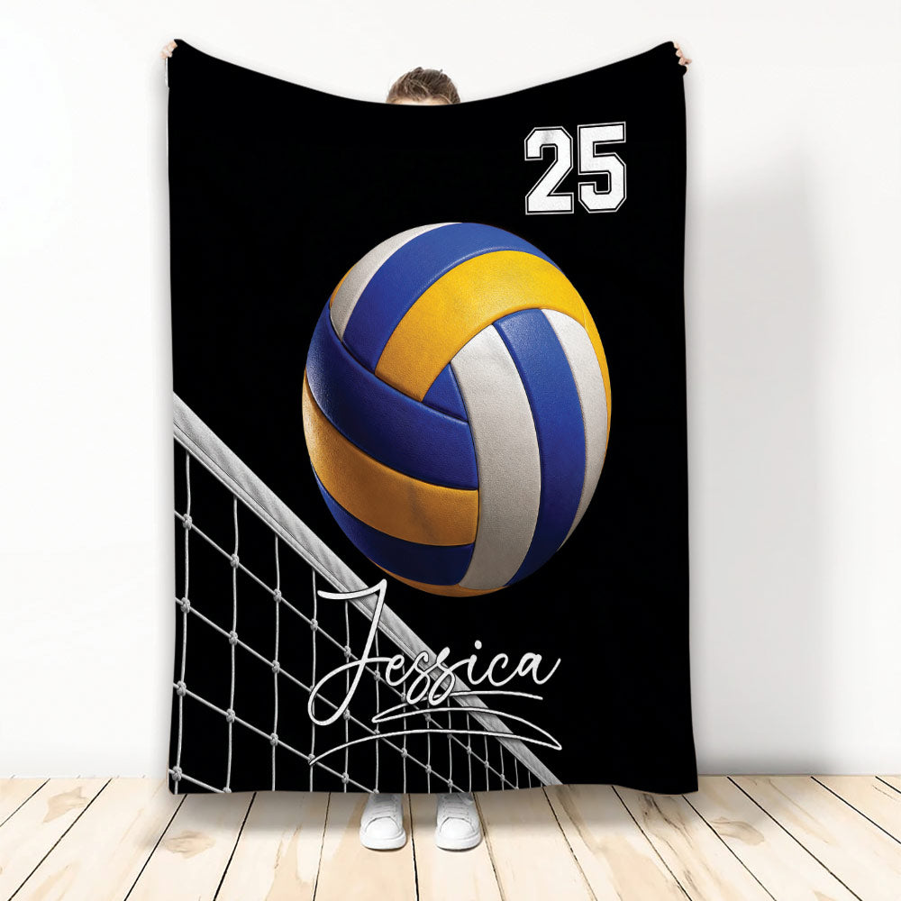 Volleyball throw blanket with blue and yellow volleyball artwork and net design on a black background
