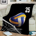 Close view of a volleyball throw blanket featuring a blue and yellow ball above a net