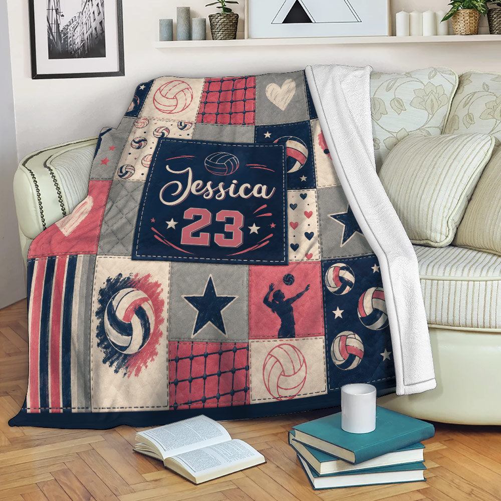 Volleyball throw blanket draped over a couch with volleyball patchwork artwork and sporty navy, red, and gray colors