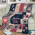 Volleyball blanket styled on a sofa with volleyballs, net patterns, stars, hearts, and player silhouettes