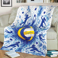 Volleyball blanket draped over a couch with blue watercolor splashes and action player silhouettes