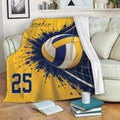 Yellow and navy volleyball blanket draped over a sofa with ball and net artwork