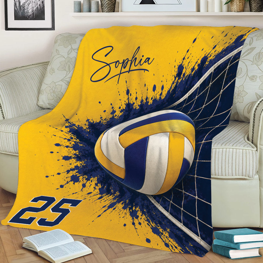 Volleyball throw blanket displayed on a couch with bold yellow, navy, ball, and net graphics