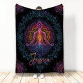 Colorful yoga meditation figure and mandala artwork on a black throw blanket