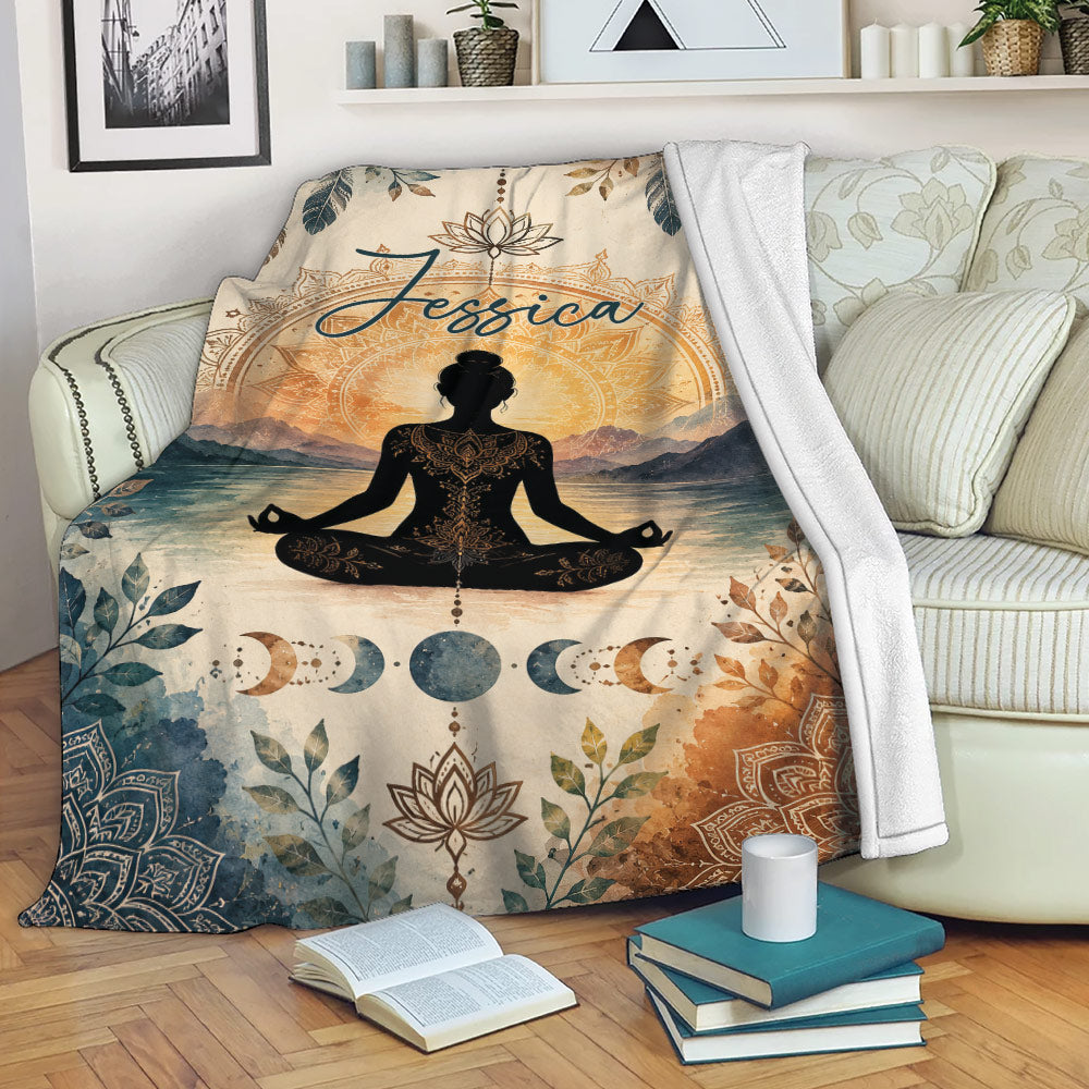 Yoga blanket draped over a sofa with meditation artwork, lotus mandala, mountains, and moon phases