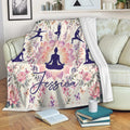 Floral yoga blanket draped over a sofa with meditation silhouettes and lotus artwork