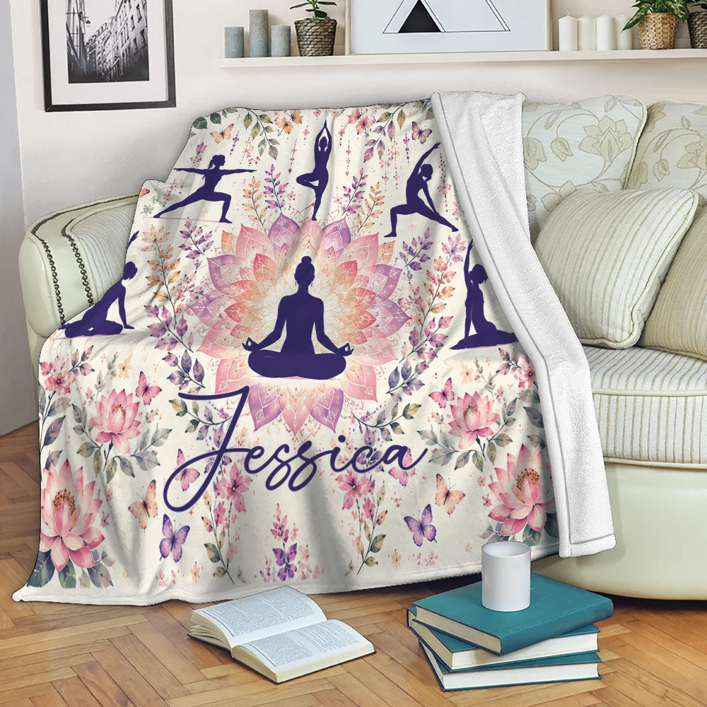 Floral yoga blanket draped over a sofa with meditation silhouettes and lotus artwork