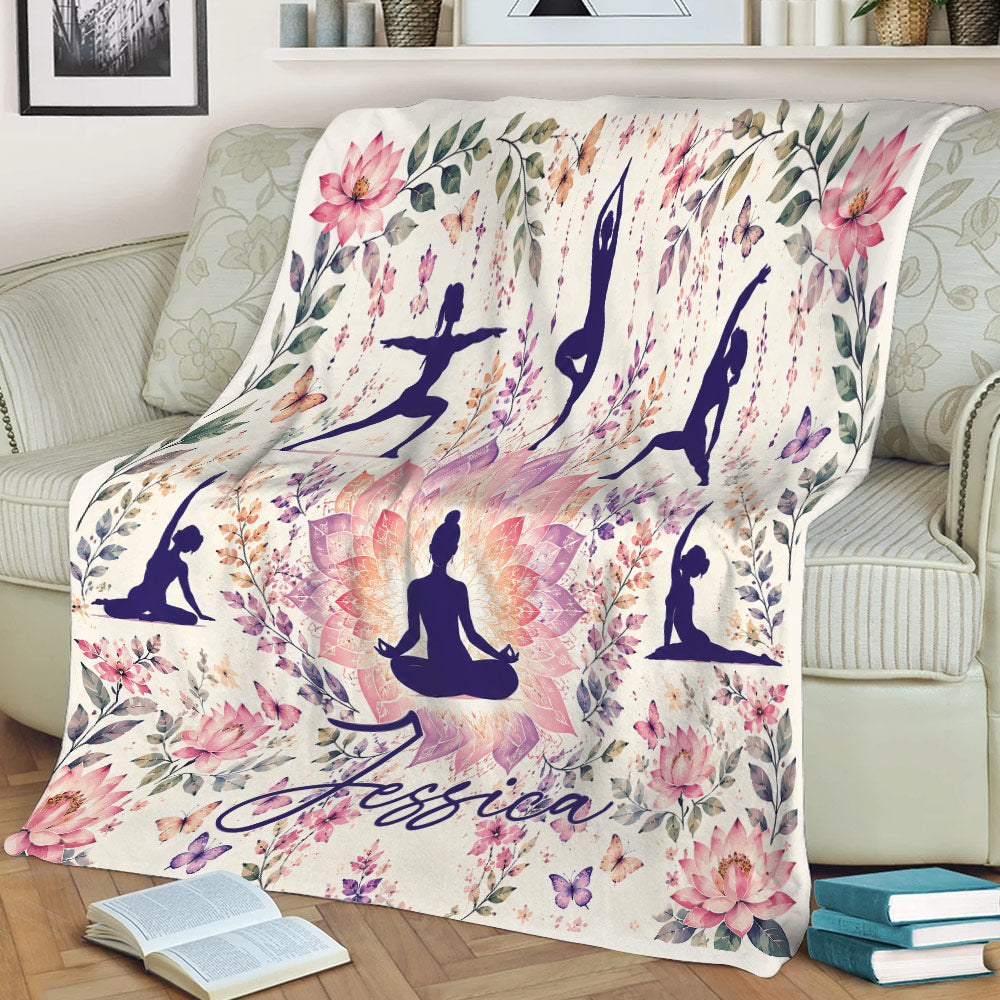 Yoga throw blanket displayed on a couch with lotus flowers, botanical details, and peaceful poses
