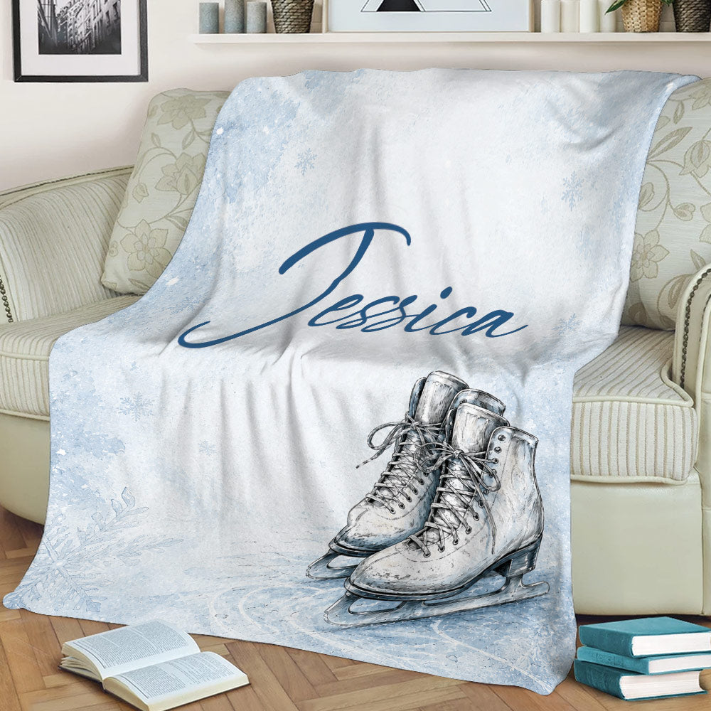 Winter ice skating blanket displayed on a couch with detailed skate illustrations and snowy blue artwork