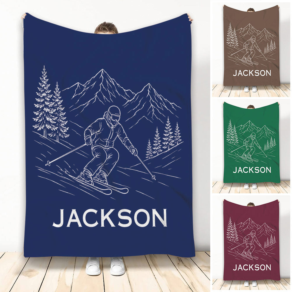 Navy skiing throw blanket featuring a line-art skier, mountain peaks, and evergreen trees