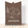 Brown skiing blanket displaying a line-art skier descending a mountain trail