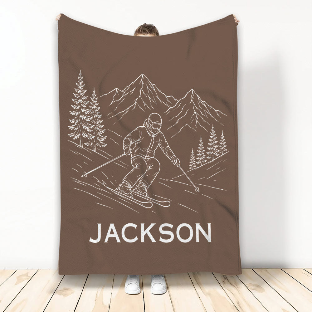 Brown skiing blanket displaying a line-art skier descending a mountain trail