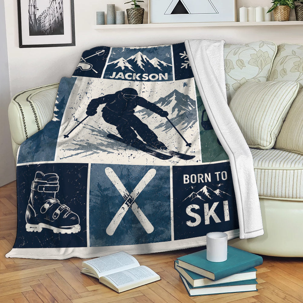 Skiing throw blanket displayed on a sofa with vintage skier, mountain, ski lift, and crossed ski artwork