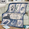 Russian Blue cat blanket draped over a couch, featuring paw, fish, yarn, moon and heart artwork