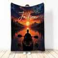 Kayak throw blanket featuring a paddler on a mountain lake beneath a dramatic sunset