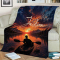 Kayak throw blanket draped across a couch with vivid sunset and mountain lake artwork