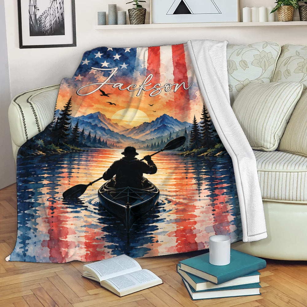 Kayak throw blanket draped over a sofa with mountain lake and patriotic watercolor artwork