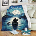 Kayak blanket draped over a sofa with mountain lake artwork, moonlit scenery, and a paddler on the water