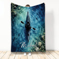 Watercolor kayak blanket featuring a paddler on blue water with fish and forest-inspired artwork