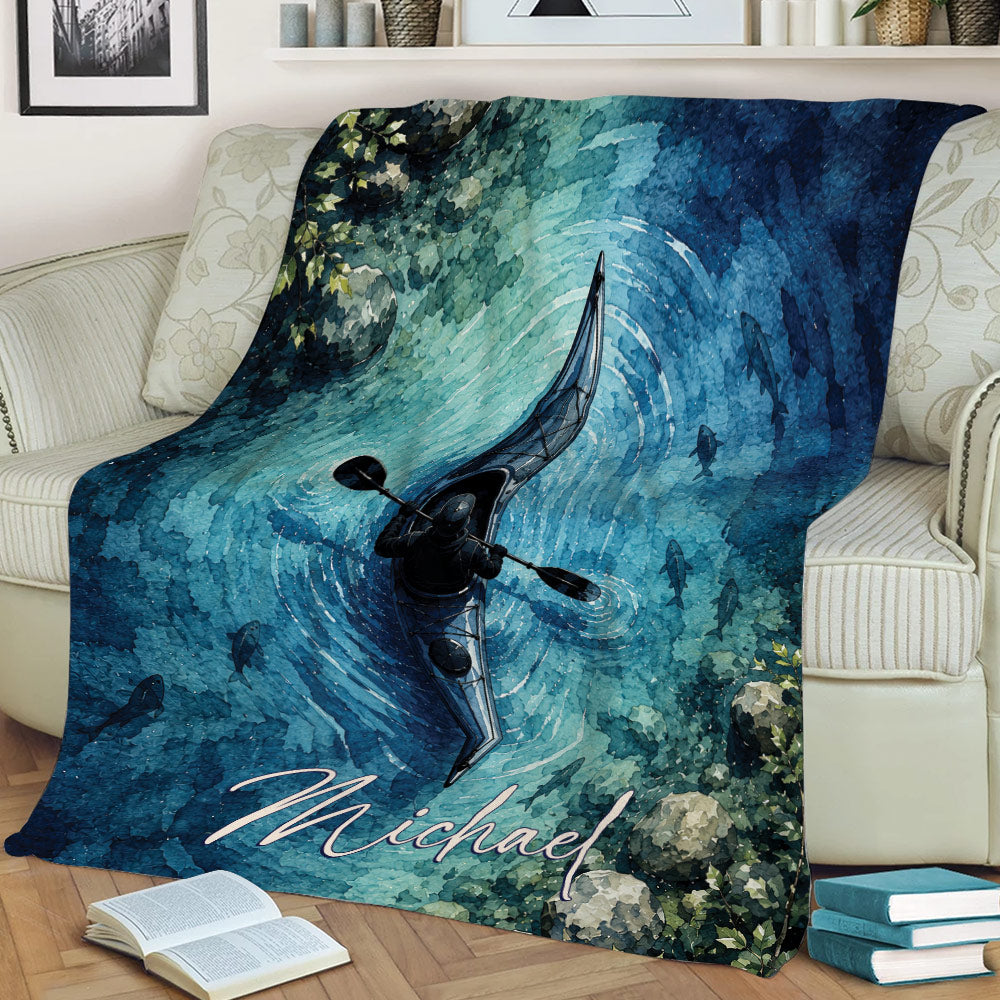 Kayak blanket draped over a sofa, showing a watercolor paddler, rippling water, and fish