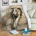 Whippet blanket displayed on a sofa with dramatic cracked wall dog artwork