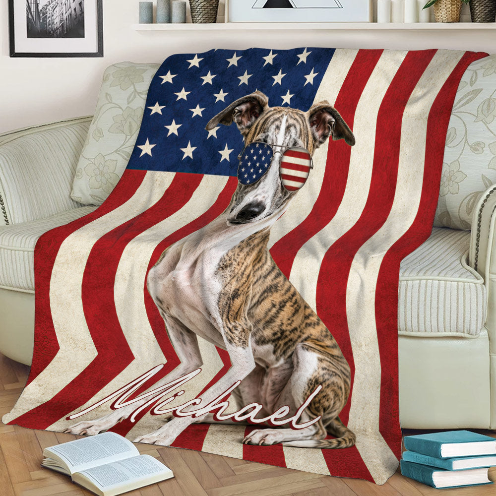 Whippet blanket draped over a sofa, featuring American flag stripes, stars, and patriotic sunglasses
