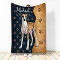 Whippet throw blanket displayed upright with paw prints and navy and tan dog-themed artwork