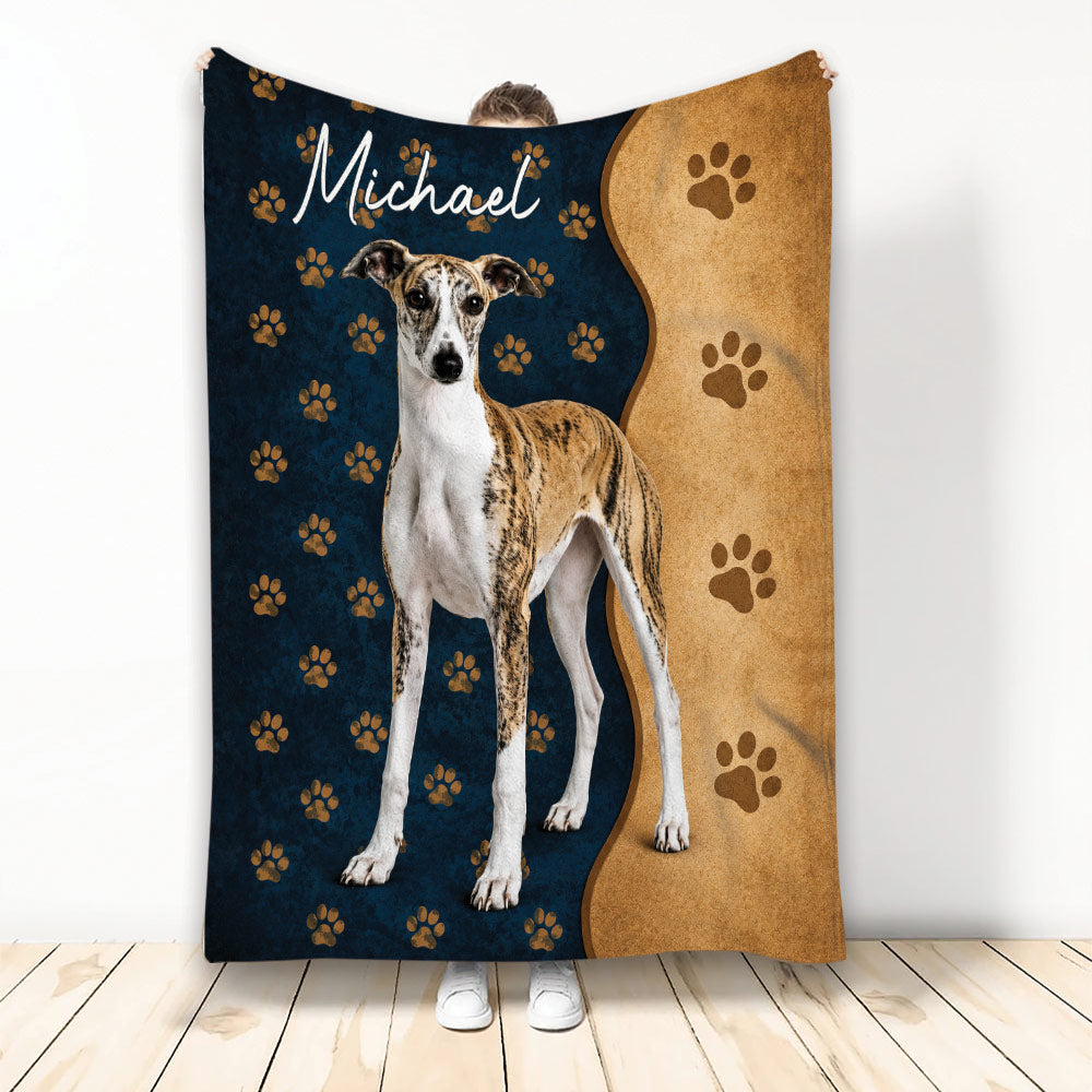 Whippet throw blanket displayed upright with paw prints and navy and tan dog-themed artwork