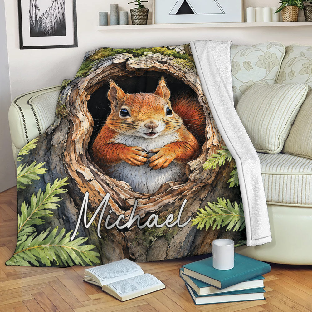 Squirrel blanket displayed on a sofa with a woodland tree hollow scene and leafy forest details