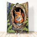 Squirrel throw blanket featuring a bright woodland squirrel emerging from a mossy tree hollow