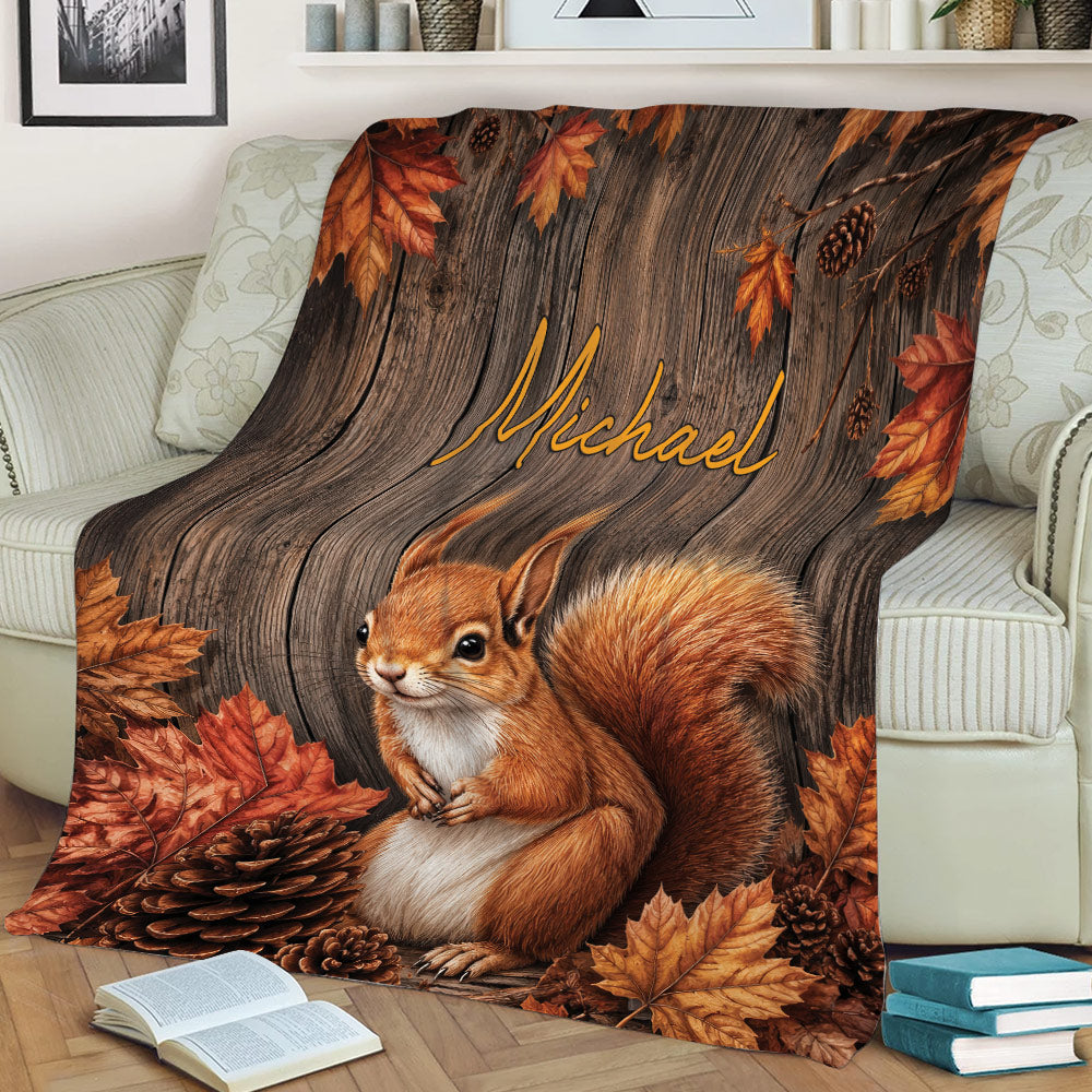 Rustic squirrel blanket with fall leaves and pinecones arranged across an armchair