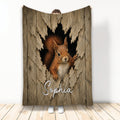 Squirrel throw blanket featuring a realistic woodland animal emerging through a rustic wooden backdrop