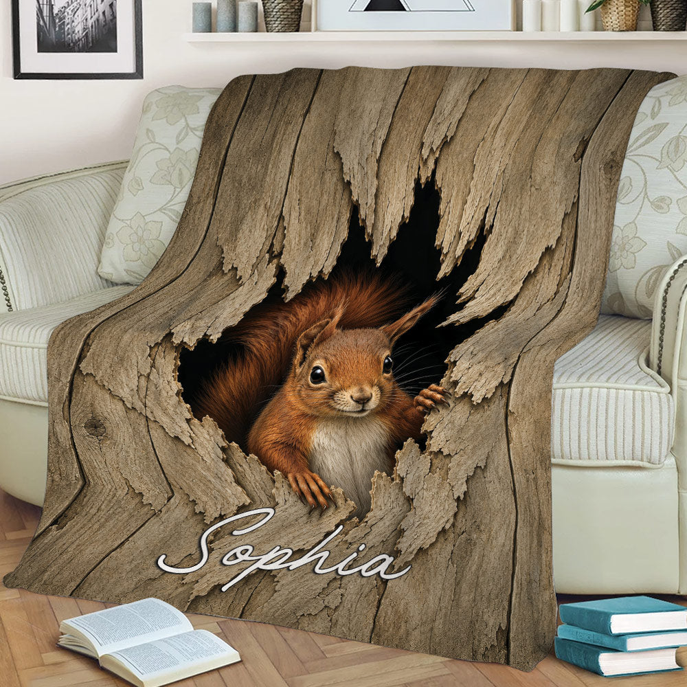 Close lifestyle view of a squirrel throw blanket draped across a sofa with woodland artwork