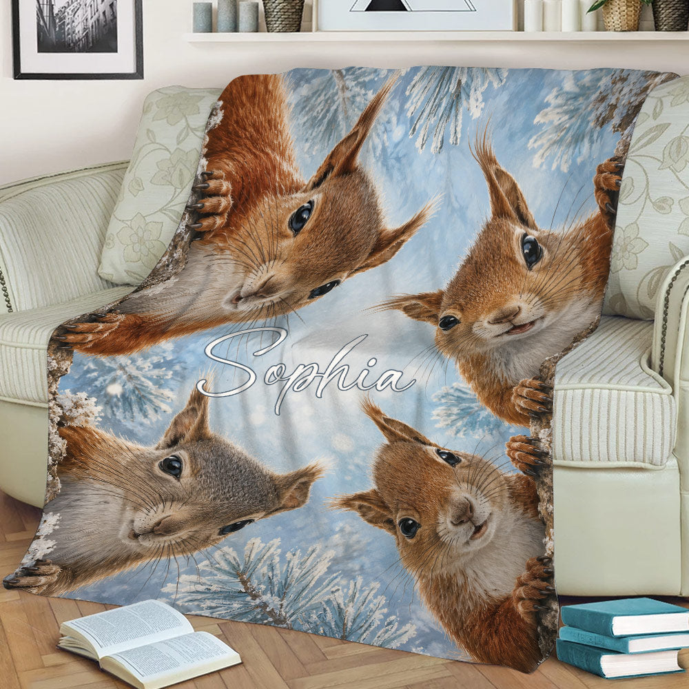 Squirrel throw blanket displayed on a chair with colorful winter woodland artwork