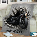 Black motorcycle throw blanket displayed on a sofa with rugged shattered wall artwork