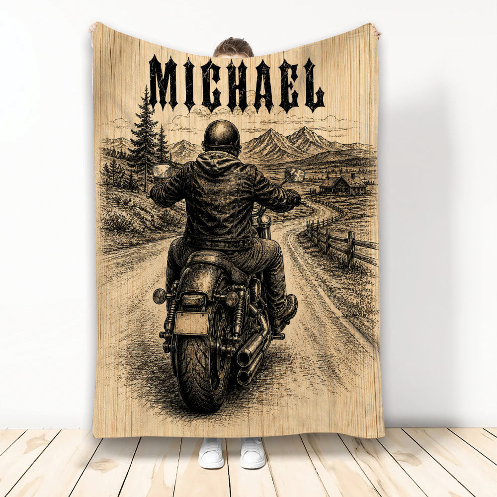 Biker blanket featuring a motorcycle rider on a mountain road with vintage black and tan artwork