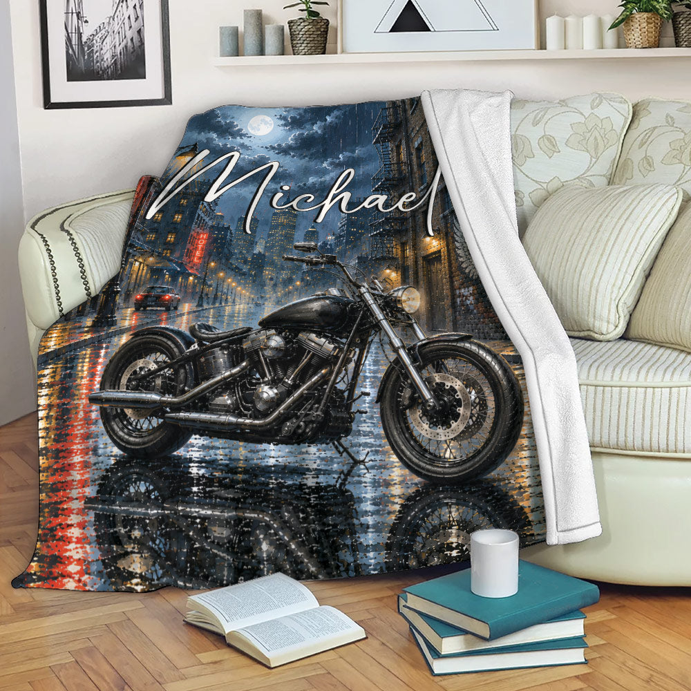 Biker throw blanket displayed on a sofa with dramatic motorcycle and urban night artwork