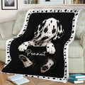 Close view of a spotted Dalmatian puppy blanket displayed on a sofa