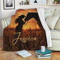 Cowgirl and horse throw blanket styled on a sofa with rustic sunset artwork