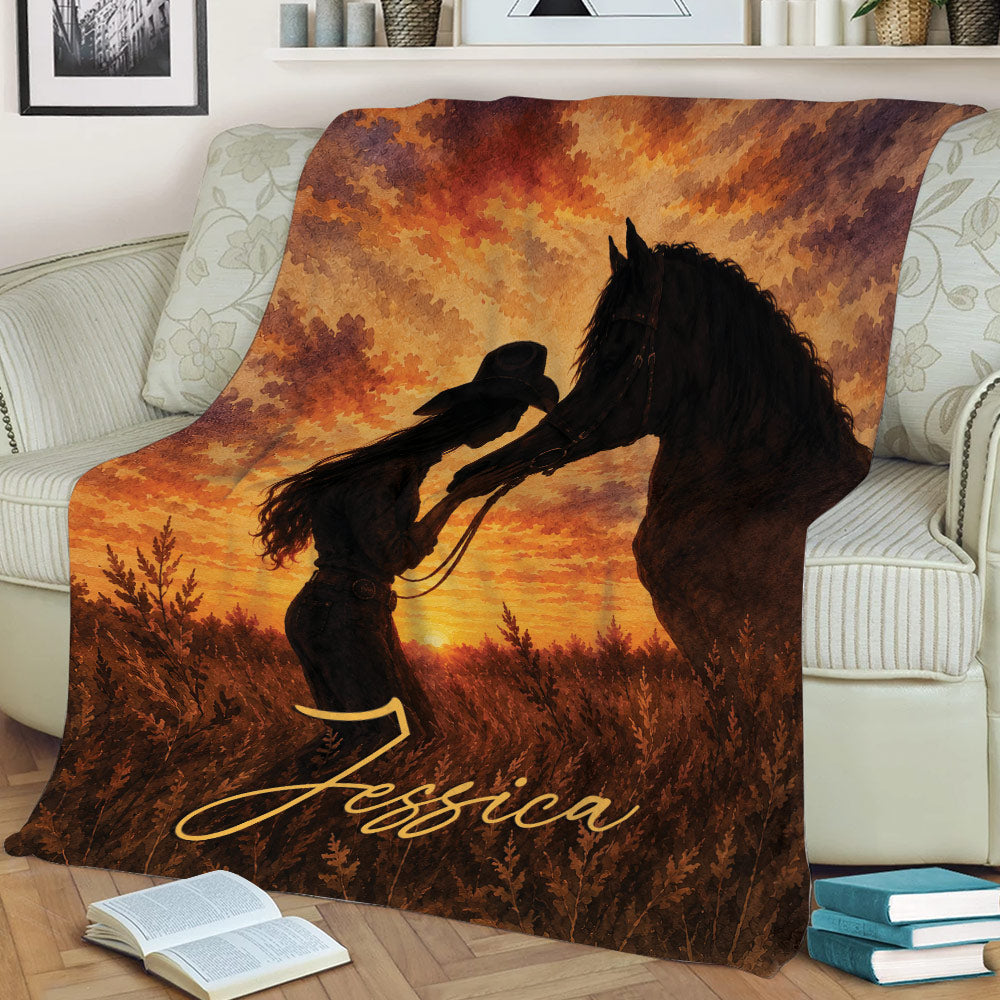 Rustic cowgirl and horse blanket draped across a sofa with warm Western landscape artwork