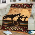 Western cowgirl throw blanket draped over a chair with horse, sunset, horseshoe, and Southwestern design
