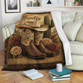 Cowgirl blanket draped over a sofa with Western boots, cowboy hat, cactus, and floral desert artwork