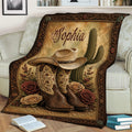 Western cowgirl throw blanket styled on a couch with cowboy boots, hat, cactus, and vintage roses