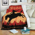 Cowgirl throw blanket draped over a sofa with Western rodeo artwork and desert landscape