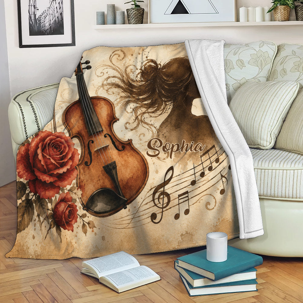 Violin throw blanket draped over a sofa with rose accents, musical notes, and vintage sepia artwork