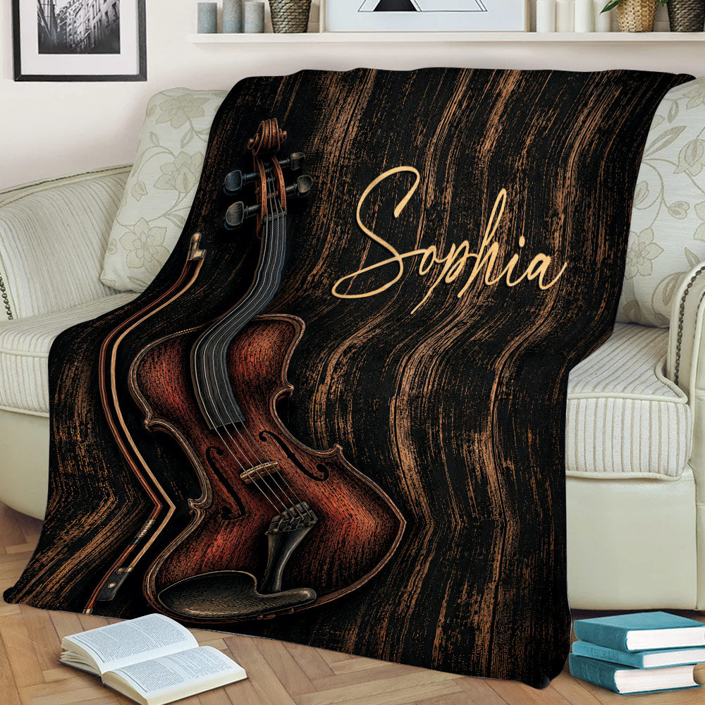 Detailed violin and bow blanket styled over a sofa with a dark rustic woodgrain background