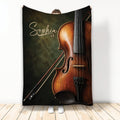 Violin and bow artwork on a dark green and brown custom throw blanket displayed upright