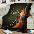 Large violin and bow artwork across a throw blanket styled on a sofa