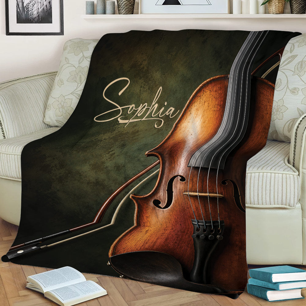 Large violin and bow artwork across a throw blanket styled on a sofa